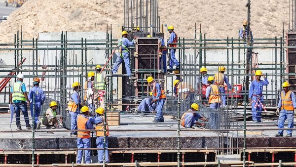 Certified scaffolders erecting Cuplock and tube-and-fittings access scaffolding at a UAE marina worksite